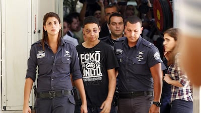 Tariq Khdeir (C), a 15-year-old American of Palestinian descent and a cousin of Mohammed Abu-Khdeir, the youth whom Palestinians believe was abducted and murdered by far-right Israelis on Wednesday, is escorted by Israeli prison guards during an appearance at Jerusalem magistrate’s court. Ronen Zvulun / Reuters