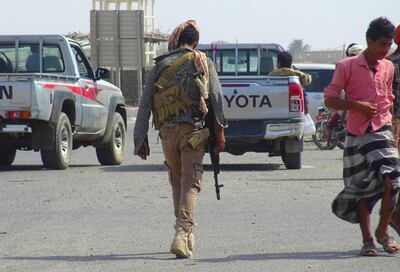 A Yemeni fighter loyal to the Saudi-backed Yemeni president walks down a street in the town of Khokha in the western province of Hodeidah on December 18. AFP
