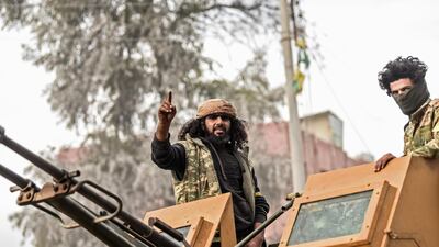 Turkish-backed Syrian Arab fighters stand on an armed vehicle after seizing control of the northwestern Syrian city of Afrin from the Kurdish People's Protection Units (YPG) on March 18, 2018. Bulent Kilic / AFP Photo