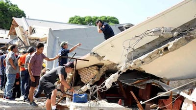 Rescue workers search for survivors amid debris after the roof of a church collapsed during Mass in Ciudad Madero on Sunday. AP