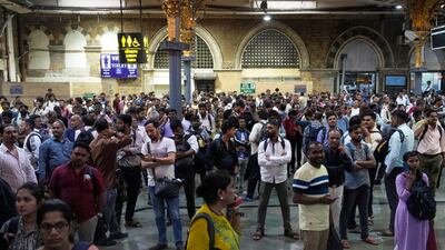 Commuters stranded at Chhatrapati Shivaji Maharaj Terminus after heavy rains disrupted rail services in Mumbai. AP