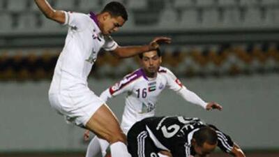 Al Jazira's Fernando Baiano, who scored the game's decisive second goal, is knocked down by Al Ain's Esmaiel Ahmed.