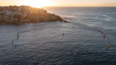 Australian surfers and lifeguards paddle out at Bondi Beach to honour the victims of the Westfield Bondi Junction stabbings in Sydney. EPA