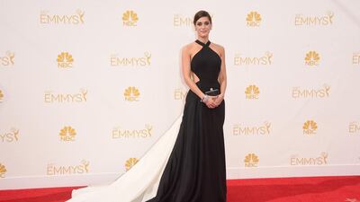 Actress Lizzy Caplan wears Donna Karan Atelier backless dress with a long white trai to the Emmy’s. Jason Merritt / Getty Images / AFP