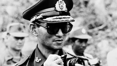 The Thai King taking a picture during his trip to Cambodia on July 7, 1980. Panasia/AFP