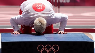 Gold medalist Anita Wlodarczyk, of Poland, kisses the podium during the medal ceremony for the women's hammer throw.