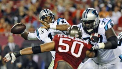 The Carolina Panthers quarterback Cam Newton, left, has matured since his early days in the NFL and started to match his prodigious talent with an equal measure of off-field class. Brian Blanco / AP Photo