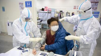 Medical staff in protective suits attend to patients at Wuhan Fang Cang makeshift hospital in Wuhan, Hubei Province, China. EPA