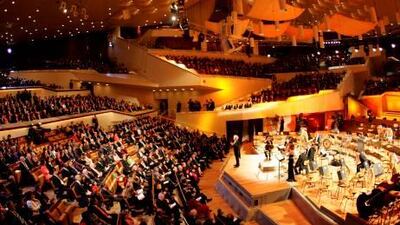 The Berlin Philharmonic performs in its concert hall in Berlin under the conductor Simon Rattle, who describes the orchestra as ‘wild tigers’ whose energy he aims to harness and guide, not control.