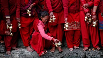 A Hindu devotee washes her feet as she waits to collect holy water from Bagmati river to perform rituals during Madhav Narayan festival in Kathmandu, Nepal. AP Photo