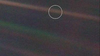 This image provided by Nasa shows the Earth as a dot in a solar system portrait taken by Voyager 1. Launched in 1977, the twin spacecraft are exploring the edge of the solar system. Voyager 1 is poised to cross into interstellar space. Nasa / AP Photo