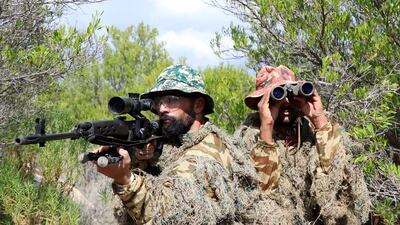 This handout picture released by the Iranian Army Media Office shows Iranian and Omani soldiers taking part in a joint in a military exercise at an undisclosed location in Oman on October 10 2024. AFP