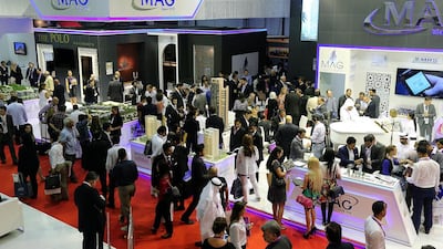 Visitors browse scaled versions of Group Mag's new projects at the Cityscape Global 2014. Satish Kumar / The National