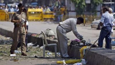 Forensic experts examine the site of a blast in New Delhi yesterday. Indian police said that 20 people were killed and nearly 100 wounded in a string of coordinated bomb attacks that ripped through busy shopping areas in the capital.