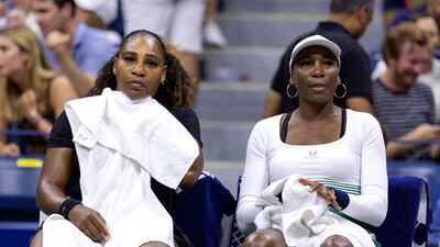 Serena Williams, left, and sister Venus sit on the bench between games against Lucie Hradecka and Linda Noskova during their 2022 US Open. AFP