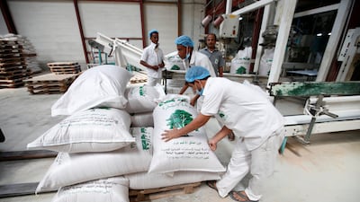 Workers prepare wheat sacks at the Red Sea port of Salif in Yemen on September 30, 2017. Yemen came sixth in this year's global hunger index. Abduljabbar Zeyad / Reuters
