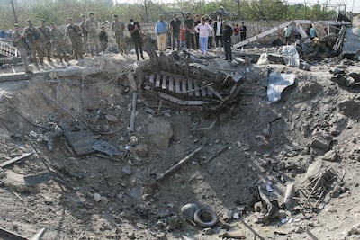 Lebanese soldiers and residents look over a crater left by an Israeli strike. AFP