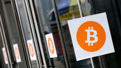 Bitcoin logos. A move by users to force a change in the computer code is supported by a majority of so-called “miners". Mark Lennihan / AP