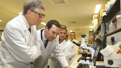 Then Chancellor of the Exchequer George Osborne and co-founder of Microsoft Bill Gates look through a microscope during a visit to the Liverpool School of Tropical Medicine in 2016. Getty Images