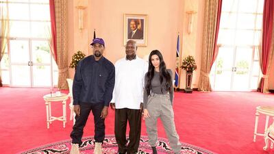 Kanye West and his wife reality TV star Kim Kardashian West pose for a photo with Uganda's President Yoweri Museveni, at State House in Entebbe, Uganda Presidential Press Unit via AP