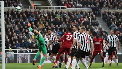 Divock Origi, red in the cente, heads home Liverpool's winner against Newcastle United. Reuters