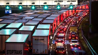 Cars and trucks queue at the UK entrance of the Eurotunnel on December 17 before increased restrictions for travel to France from Britain. Reuters