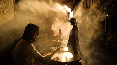 Customers seek shade at a coffee shop amid a heatwave in the French Riviera city of Nice. AFP