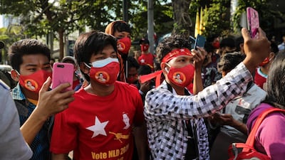 People use their smartphones to live stream a protest outside Myanmar's embassy in Bangkok, Thailand. Getty Images