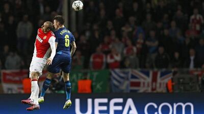AS Monaco forward Dimitar Berbatov, left, goes for a header against Arsenal defender Laurent Koscielny in their Champions League match on Tuesday. Valery Hache / AFP
