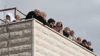 Mourners watch the funeral procession of two Palestinians who died following an Israeli raid in Dura, south of Hebron, on Monday. The Palestinian Authority's failure to counter Israeli settlements or security crackdowns has left many West Bank residents disillusioned. AFP