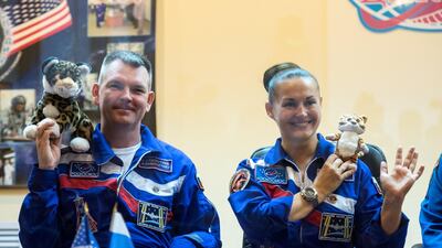 In September 2012, Expedition 41 Soyuz Commander Alexander Samokutyaev and Flight Engineer Elena Serova of Roscosmos hold up tiger toys that will be carried with them to the International Space Station to commemorate International Tiger Day. Aubrey Gemignani / Nasa
