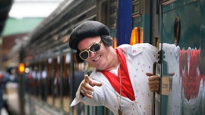 An Elvis fan boards the ‘Elvis Express’ at Central Station in Sydney, Australia. Lisa Maree Williams / Getty Images