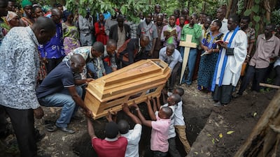 Relatives mourn as the coffin of Florence Masika, who was killed along with her son Zakayo Masereka by suspected rebels as they retreated from Saturday's attack on the Lhubiriha Secondary School, is buried in Nyabugando, Uganda. The attack by extremists left at least 42 people dead, most of them pupils. AP