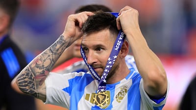 Lionel Messi of Argentina puts on his medal after his side's victory in the Copa America final. AP