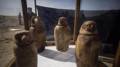 Four canopic jars, made of alabaster with lids bearing the faces of the four sons of god Horus, that were unearthed are displayed at the site of an ancient Egyptian cemetery, in Minya province, 245km south of Cairo, Egypt. According to the Ministry of Antiquities, an ancient Egyptian cemetery was discovered 6km north of the Tuna al-Gabal archaeological site in Minya, containing a number of burial shafts dating to the late pharaonic period and early Ptolemaic era. The archaeological mission unearthed a mummy decorated with a bronze collar, 1000 figurines, some 40 sarcophagi, four canopic jars, and other funerary items. Ibrahim Youssef / EPA