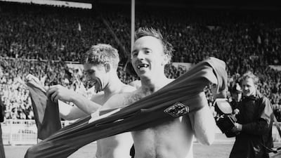 Teammates Alan Ball, left, and Nobby Stiles celebrate after England's victory in the 1966 World Cup final at Wembley in 1966. Getty