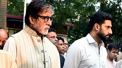 Bollywood actors Amithabh Bachchan and Abhishek Bachchan attend the funeral of Krishna Raj Kapoor, wife of late actor Raj Kapoor, in Mumbai. AFP