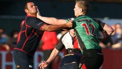 Mike McFarlane, right, hands off Trent Eastgate of Jebel Ali Dragons in the Sevens tournament.