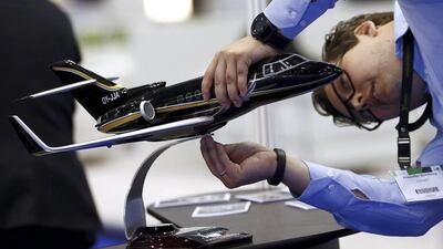 A staff installs an aircraft replica on the Joinjet booth. Denis Balibouse / Reuters