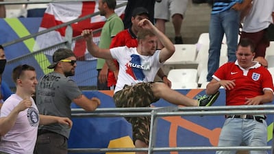 Russian supporters attack an England fan at the end of a Euro 2016 game. Thanassis Stavrakis / AP