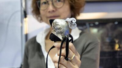 Miwako Yangisawa shows off her jewellery for animals at Abu Dhabi International Hunting and Equestrian Exhibition Leslie Pableo for The National 