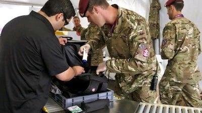British soldiers check a bag at the entry of Olympic Park in Stratford, London in the lead-up to the Olympic Games from July 27.