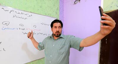 Yasir Sabah, an Arabic teacher, conducts an online lesson to his students by his mobile phone in Fallujah city, western Baghdad. EPA