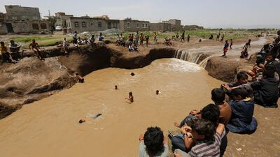 Yemenis swimming in floodwaters following heavy rains in Sanaa, Yemen. Yahya Arhab / EPA