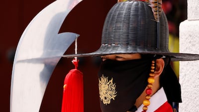 A man wearing traditional dress wears a mask to prevent the spread of the coronavirus during the daily re-enactment of the changing of the Royal Guards at Gyeongbok Palace in central Seoul. Reuters