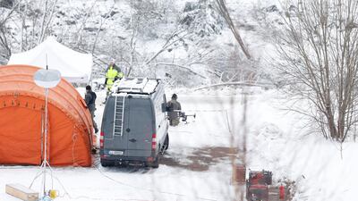 Rescue crews work with a drone in the landslide area at Ask. Reuters