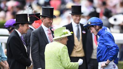 Queen Elizabeth II speaks to Doyle. EPA