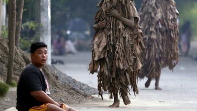 Residents collect candles before attending mass. Bullit Marquez / AP Photo