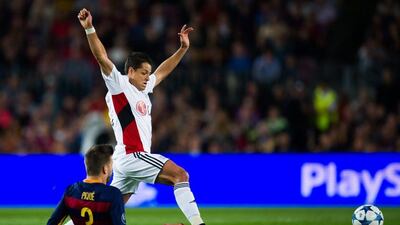 Bayer Leverkusen's Javier Hernandez tries to play the ball past Gerard Pique of Barcelona during their Champions League match at the Camp Nou on Tuesday night. Alex Caparros / Getty Images