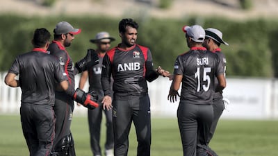 Amir Hayat, centre, of the UAE takes the wicket of Chris Lynn of Australia during Monday's Twenty20 clash. All photos by Chris Whiteoak